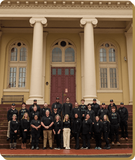 RAM Restoration team standing in front of a building